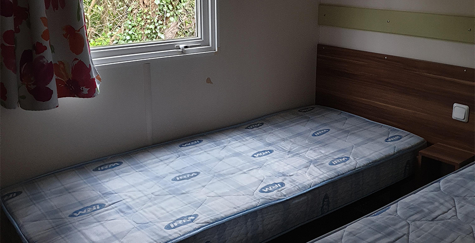 The bedroom with two single beds in the 4-person mobile home, available for rental at The Léhan campsite in Brittany